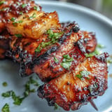 Smoky al pastor chicken skewers with bright, caramelized pineapple chunks.