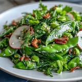Freshly tossed Snap Pea and Radish Spring Salad with Tahini, ready to serve as a light lunch.