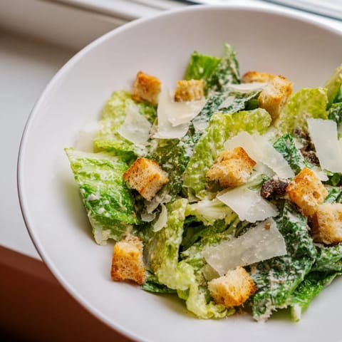 This Caesar salad is a flavorful Italian-American dish with crisp romaine and grated cheese.