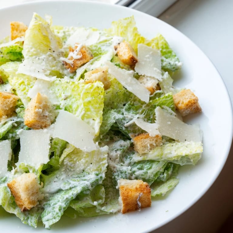 Delicious homemade Caesar salad, a classic salad recipe, ready for plating and enjoyment.