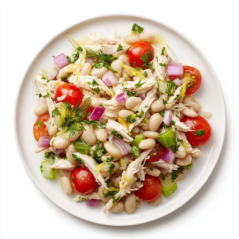 Freshly tossed Lemony White Bean Chicken Salad in a rustic serving dish, highlighting protein-rich ingredients and vibrant herbs—perfect for a light, gluten-free lunch.