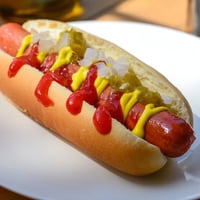 Steaming hot dogs, nestled in toasted buns, and generously piled with classic toppings.