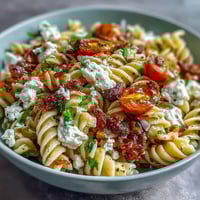 A vibrant bowl of Easy Picnic Pasta Salad with Italian Dressing, featuring colorful vegetables and mozzarella pearls.