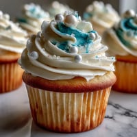 Soft vanilla Cancer birthday cupcakes adorned with shimmery pearl fondant, a delightful dessert.